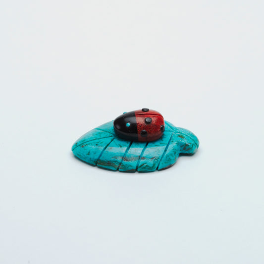 Georgette Quam: Coral/Jet Ladybug on Kingman Turquoise Leaf
